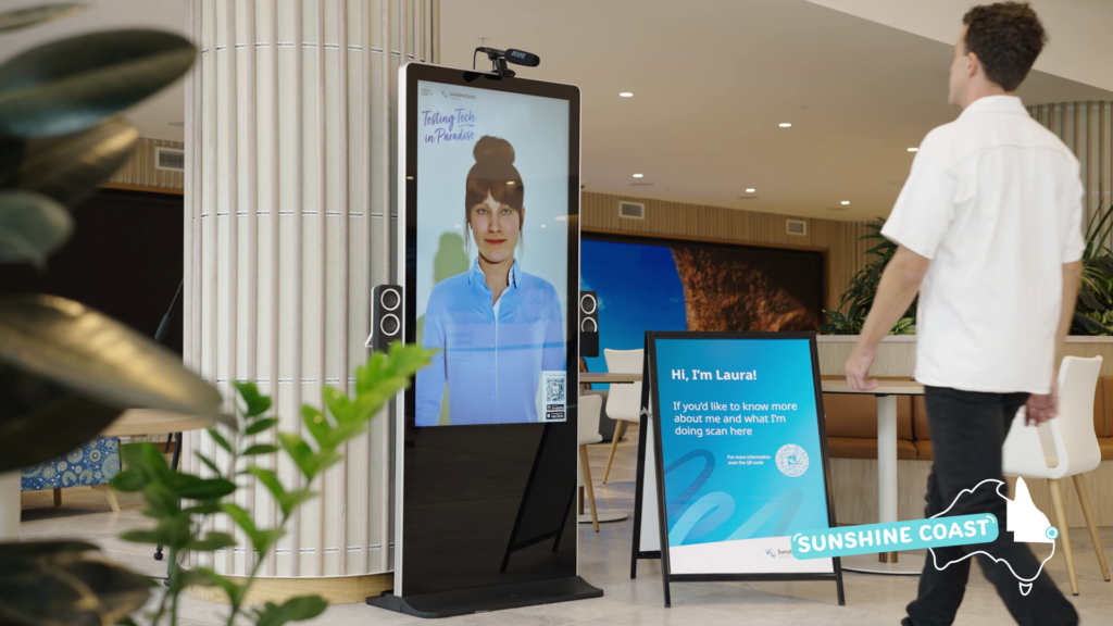 A customer walks up to a life-size AI avatar, highlighting the technology’s role in improving service efficiency.